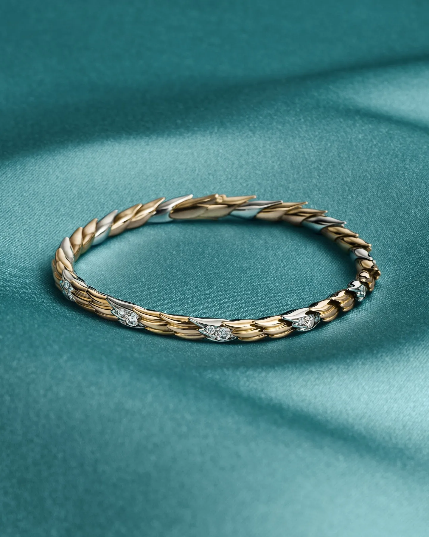Articulated bracelet from Tiffany & Co.'s Bird on a Rock collection in 18k gold and platinum featuring sculptural diamond-set wings