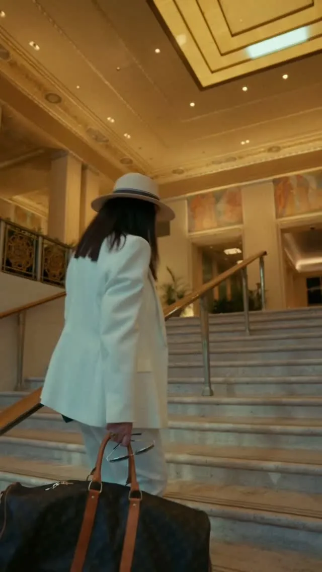 Evi Photopoulos, inaugural Artist in Residence at Waldorf Astoria New York, engaged in live painting within the hotel's iconic spaces