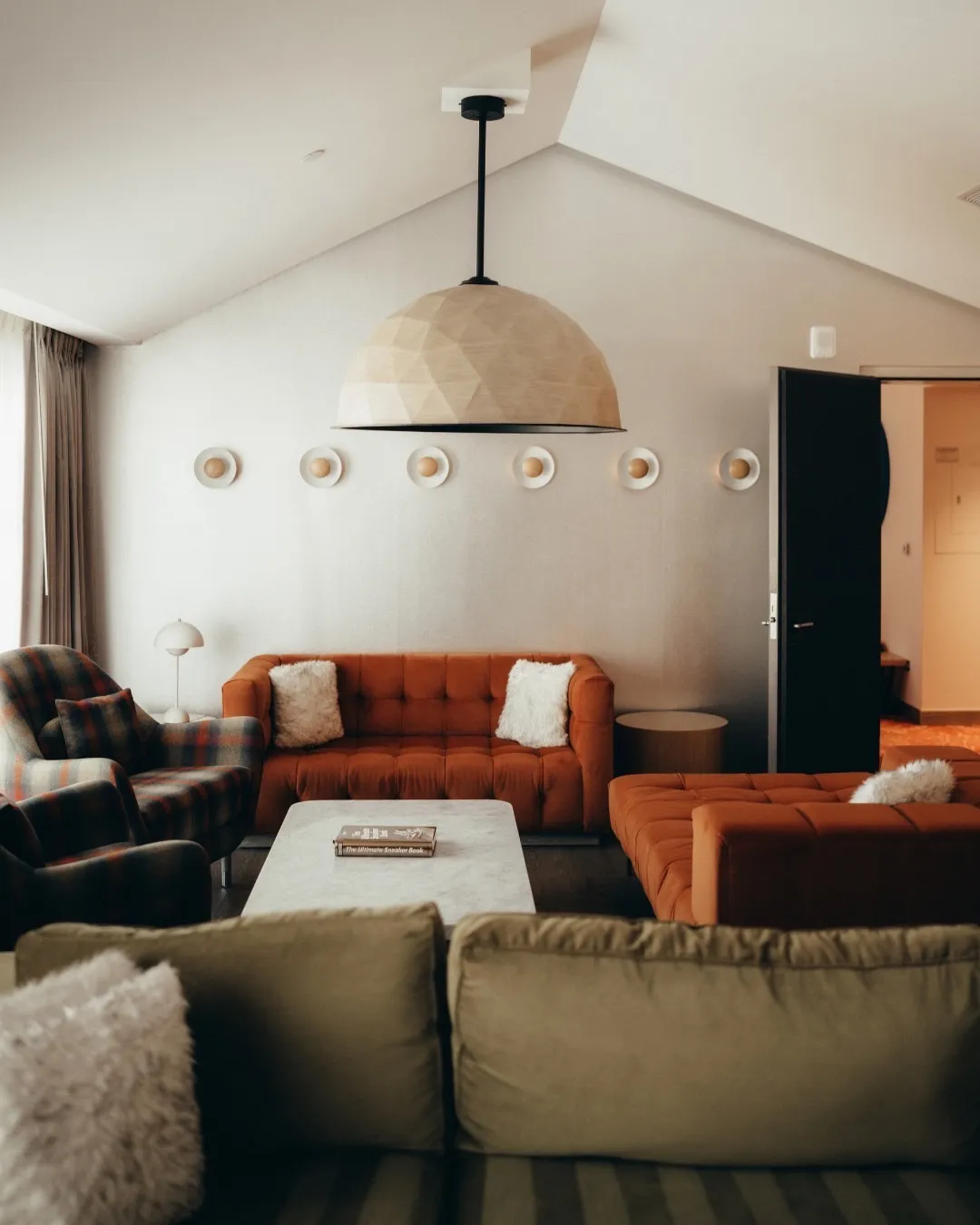 Statement seating in deep earthy colours positioned within W Hotels' fall-curated lounge space