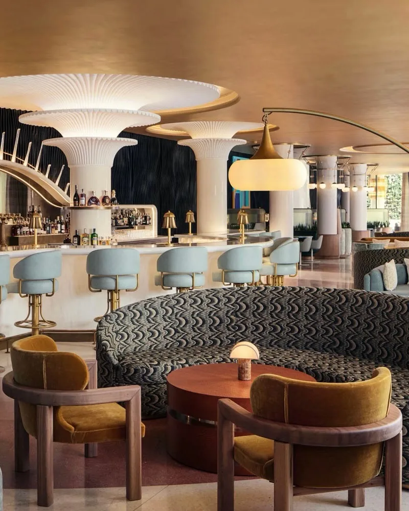 W Hotels public space showcasing burnished gold tones and sculptural furniture arrangement