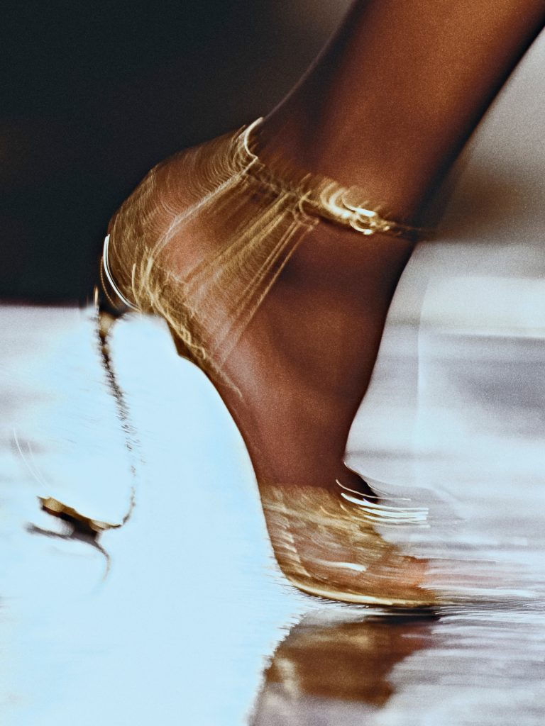 Detail of a flowing silk slip dress showcasing the refined craftsmanship of Saint Laurent's summer pieces