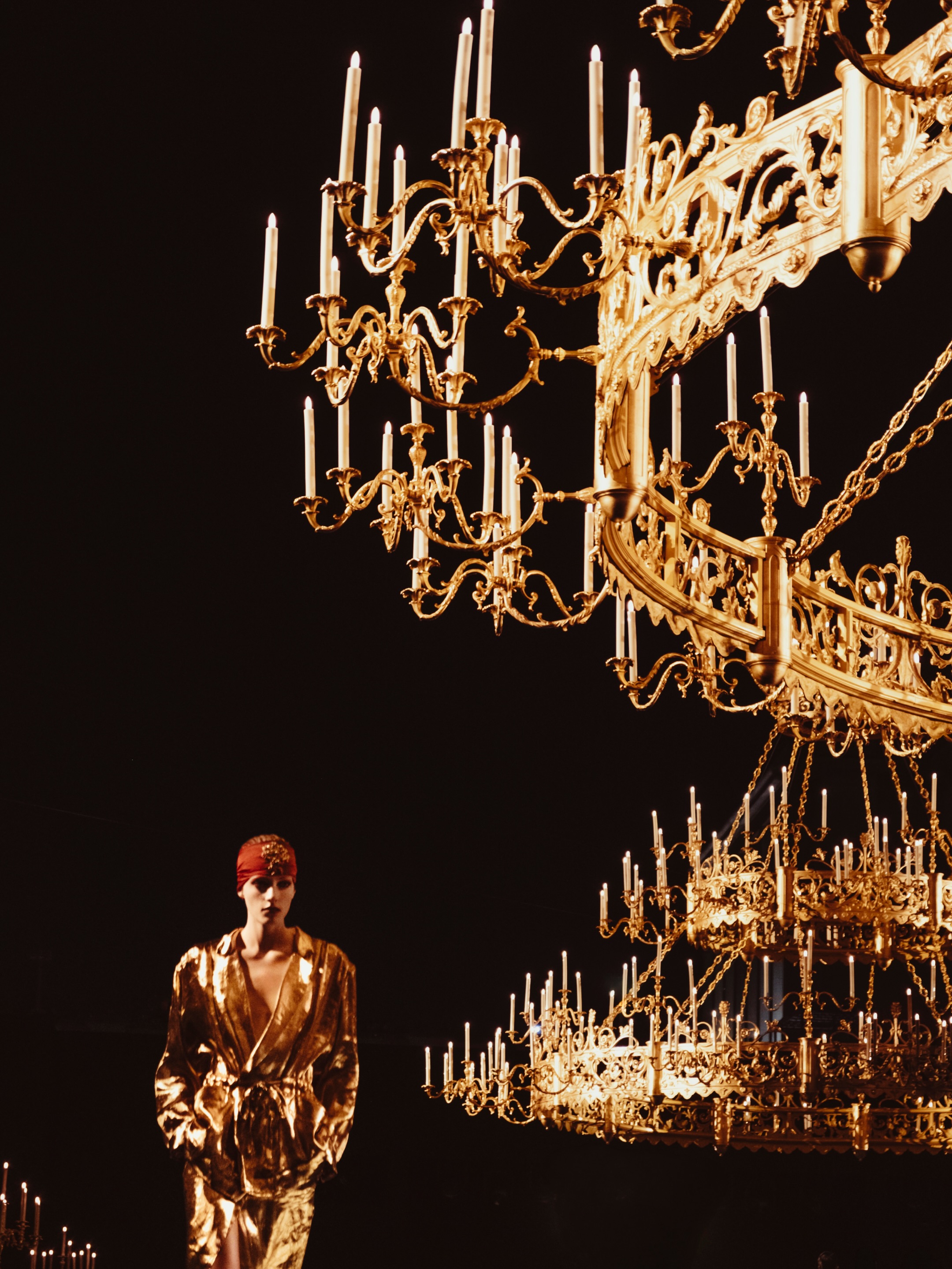 A figure in a sleeveless column dress demonstrating Saint Laurent's signature architectural cut